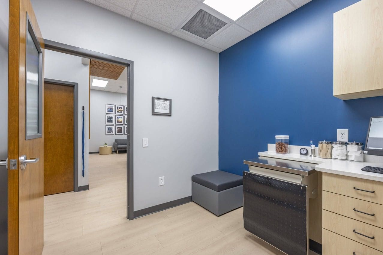 Empty exam room with exam table folded down